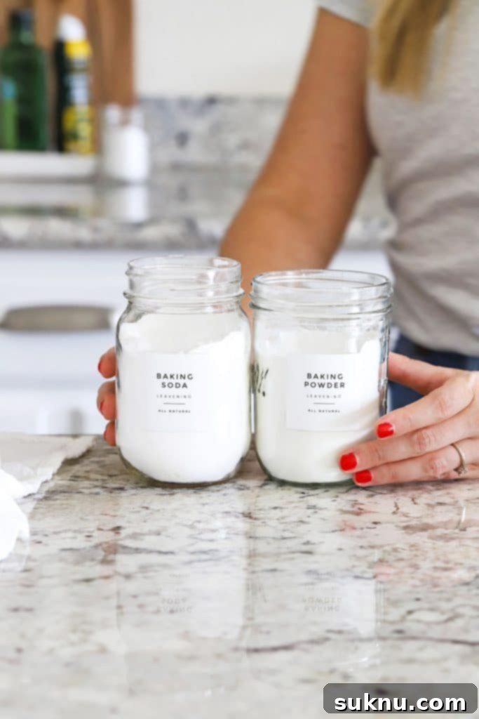 Holding jars of baking soda and baking powder