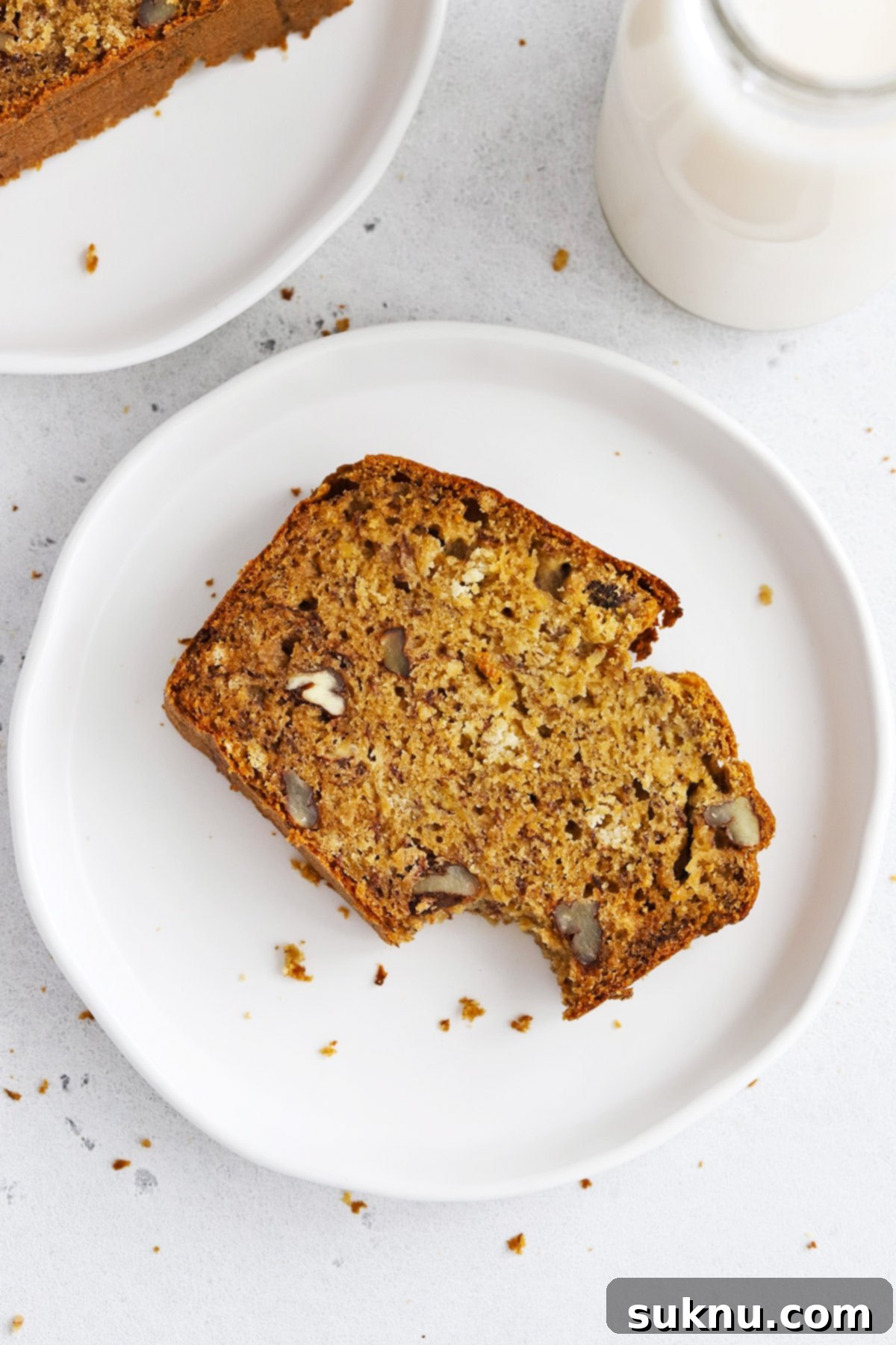 Overhead view of a perfectly baked slice of gluten-free brown butter banana bread on a serving plate.