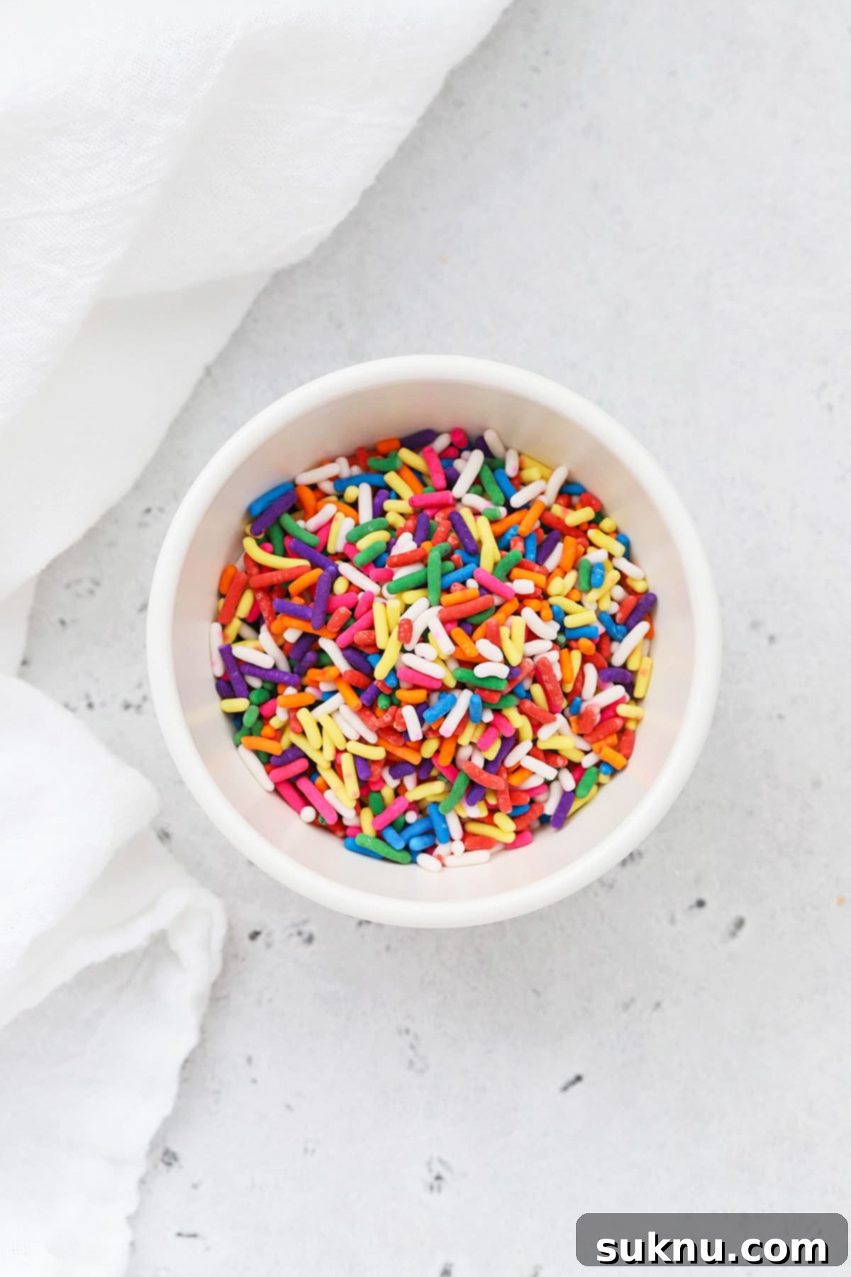 Colorful jimmies sprinkles sprinkles in a white bowl