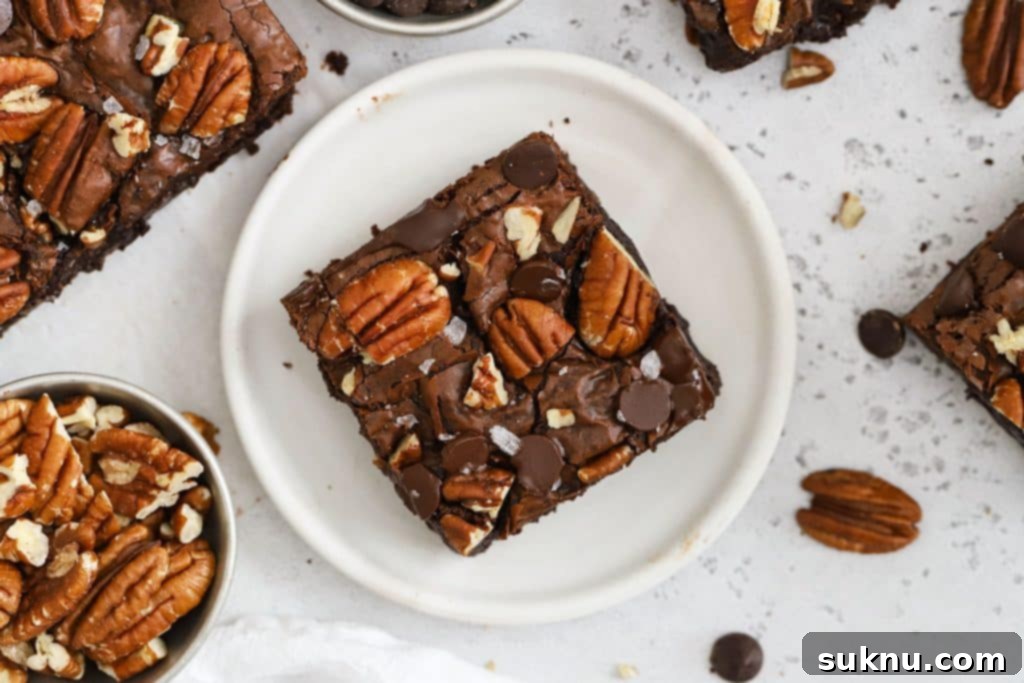 Fudgy Golden Brown Butter Gluten-Free Brownies 11 gluten-free pecan brownie on a white plate