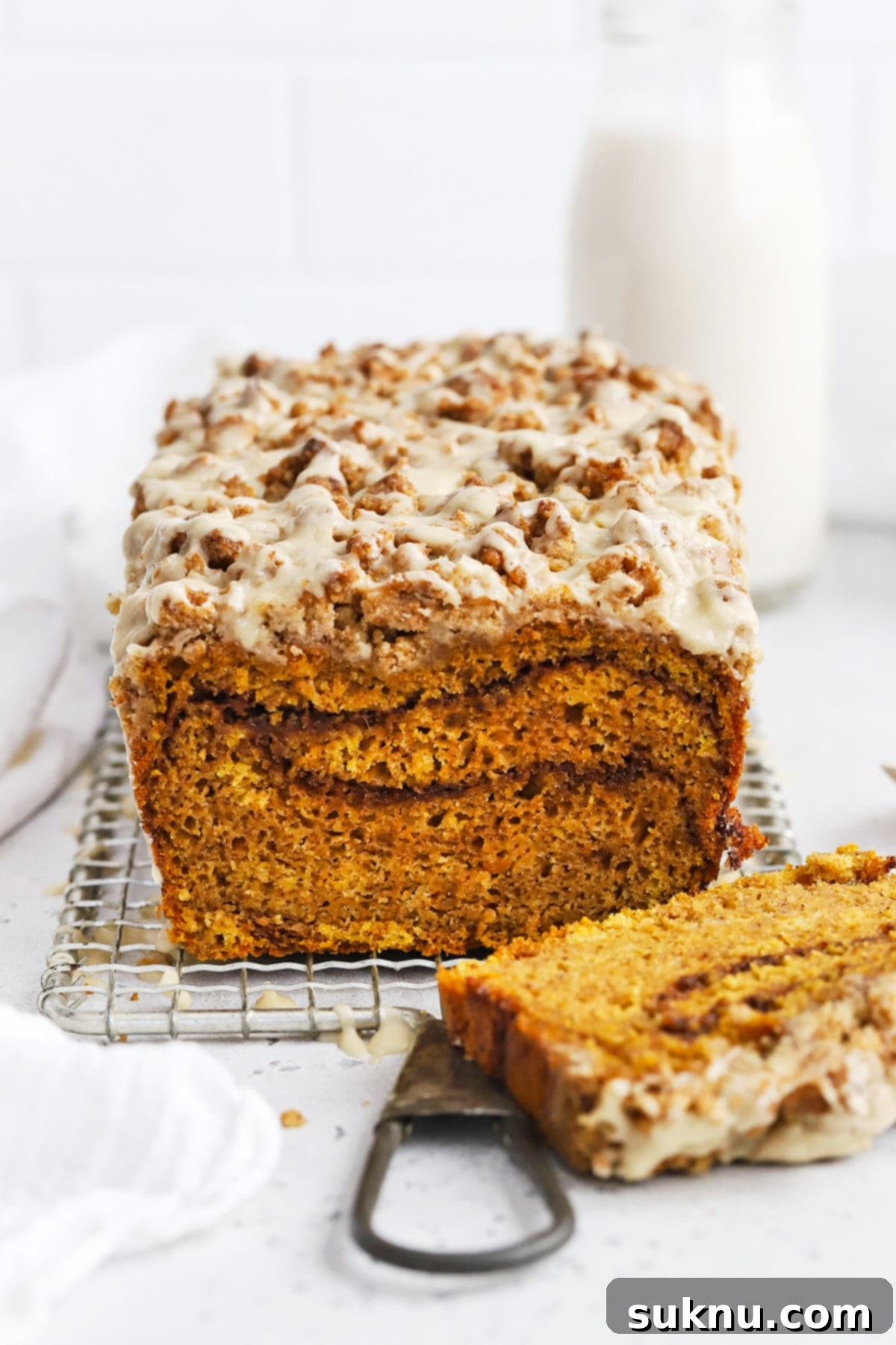 Front view of gluten-free pumpkin streusel bread with maple glaze and cinnamon swirl