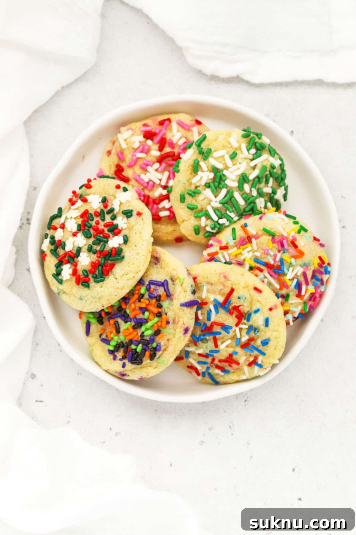 Sprinkled Gluten Free Sugar Cookies 6 A joyful image of gluten-free holiday sugar cookies with festive red and green sprinkles, perfect for seasonal celebrations.