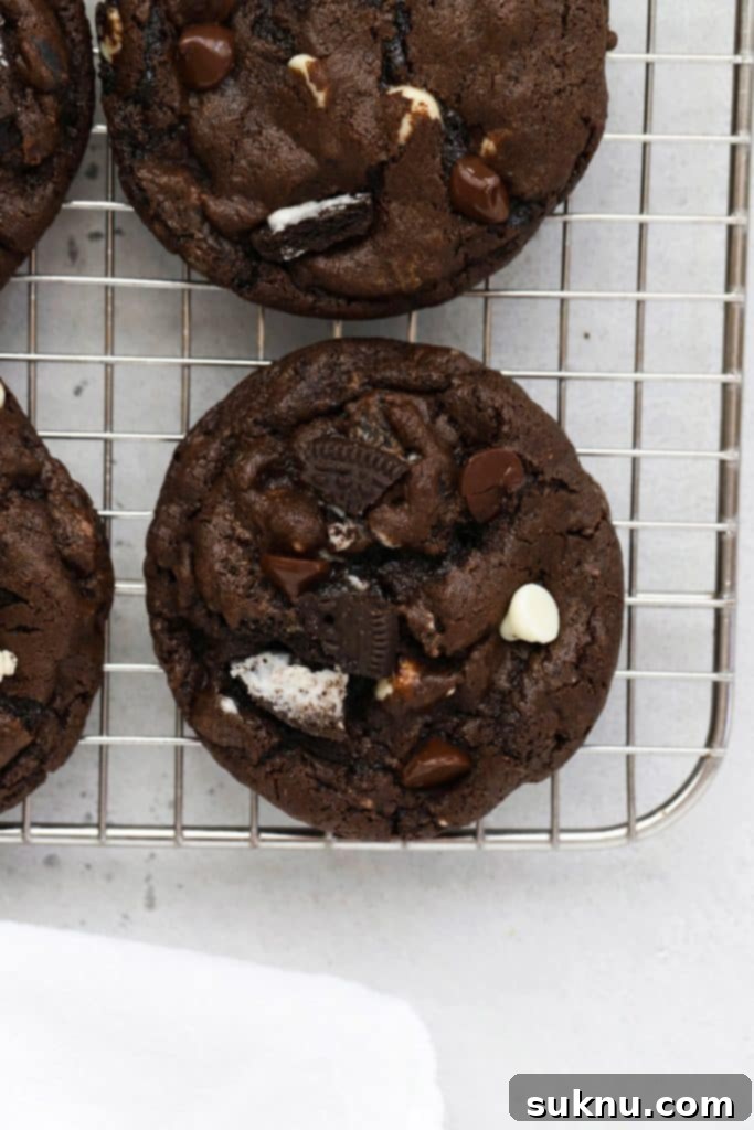 Overhead view of gluten-free chocolate cookies and cream cookies cooling on a wire rack.