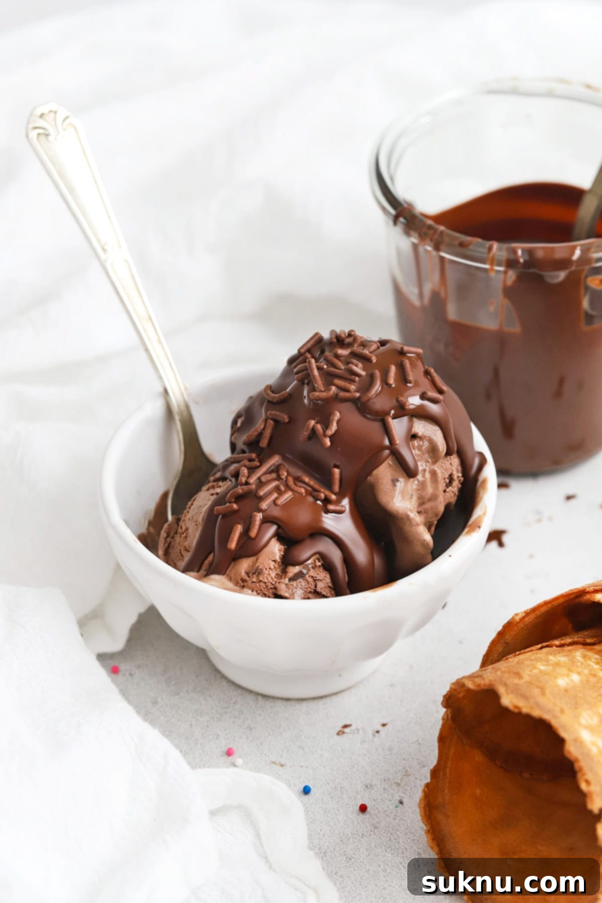 Transform Your Ice Cream: 2-Ingredient Magic Chocolate Shell 9 Homemade 2 ingredient magic chocolate shell on chocolate ice cream, topped with colorful sprinkles for a festive look