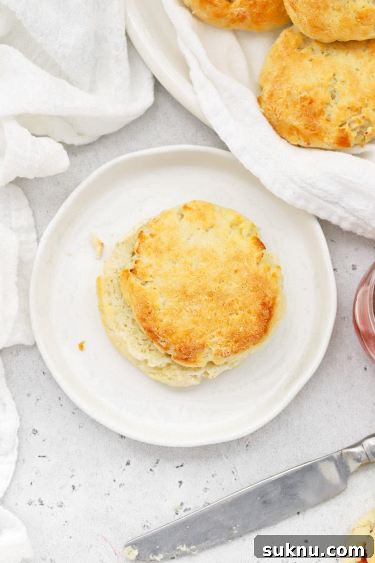 An overhead shot showcasing a platter of perfectly golden, fluffy gluten-free biscuits.