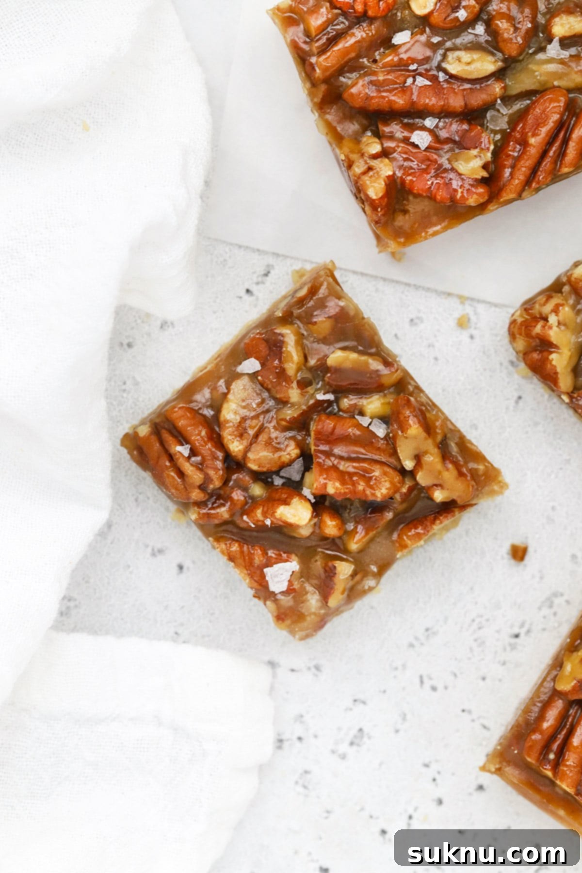 Sweet and Salty Gluten-Free Pecan Caramel Treats 2 Overhead view of perfectly cut gluten-free salted caramel pecan bars ready to serve