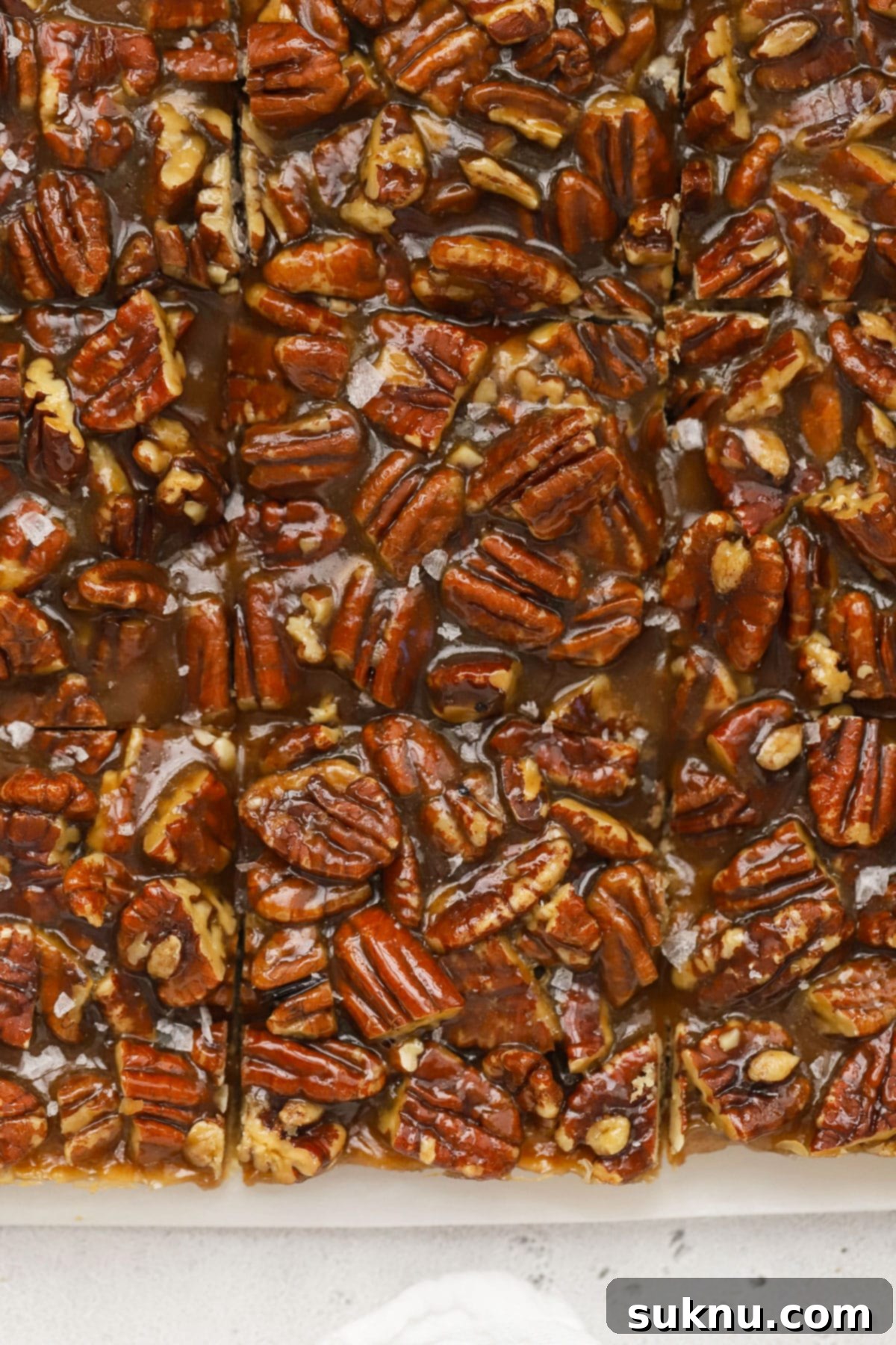 Sweet and Salty Gluten-Free Pecan Caramel Treats 6 Gluten-free caramel pecan pie bars cut into neat squares, showing the rich filling and crust