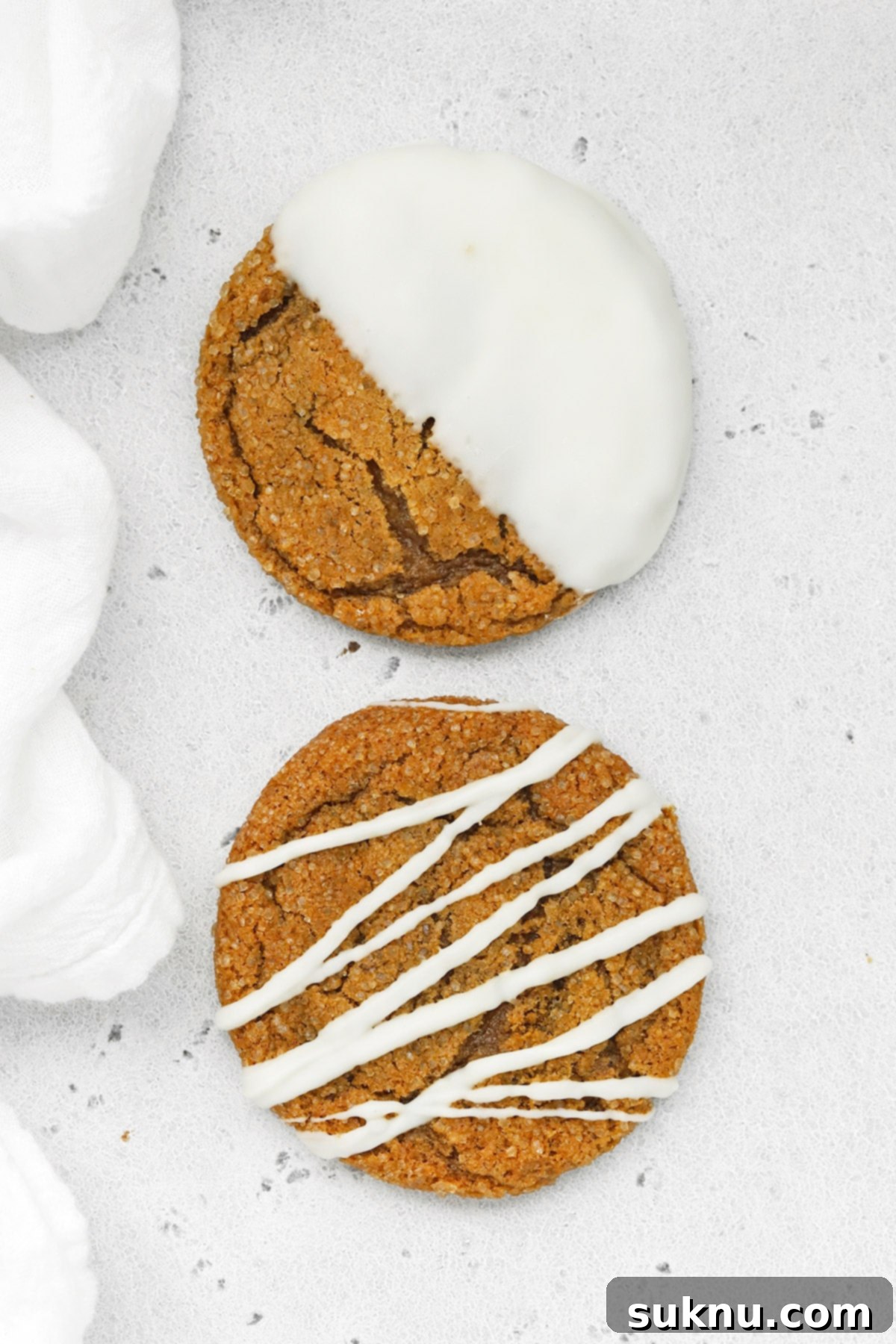 Overhead view of soft, chewy gluten-free ginger cookies drizzled and dipped in white chocolate