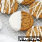 Front view of soft, chewy gluten-free ginger cookies drizzled and dipped in white chocolate