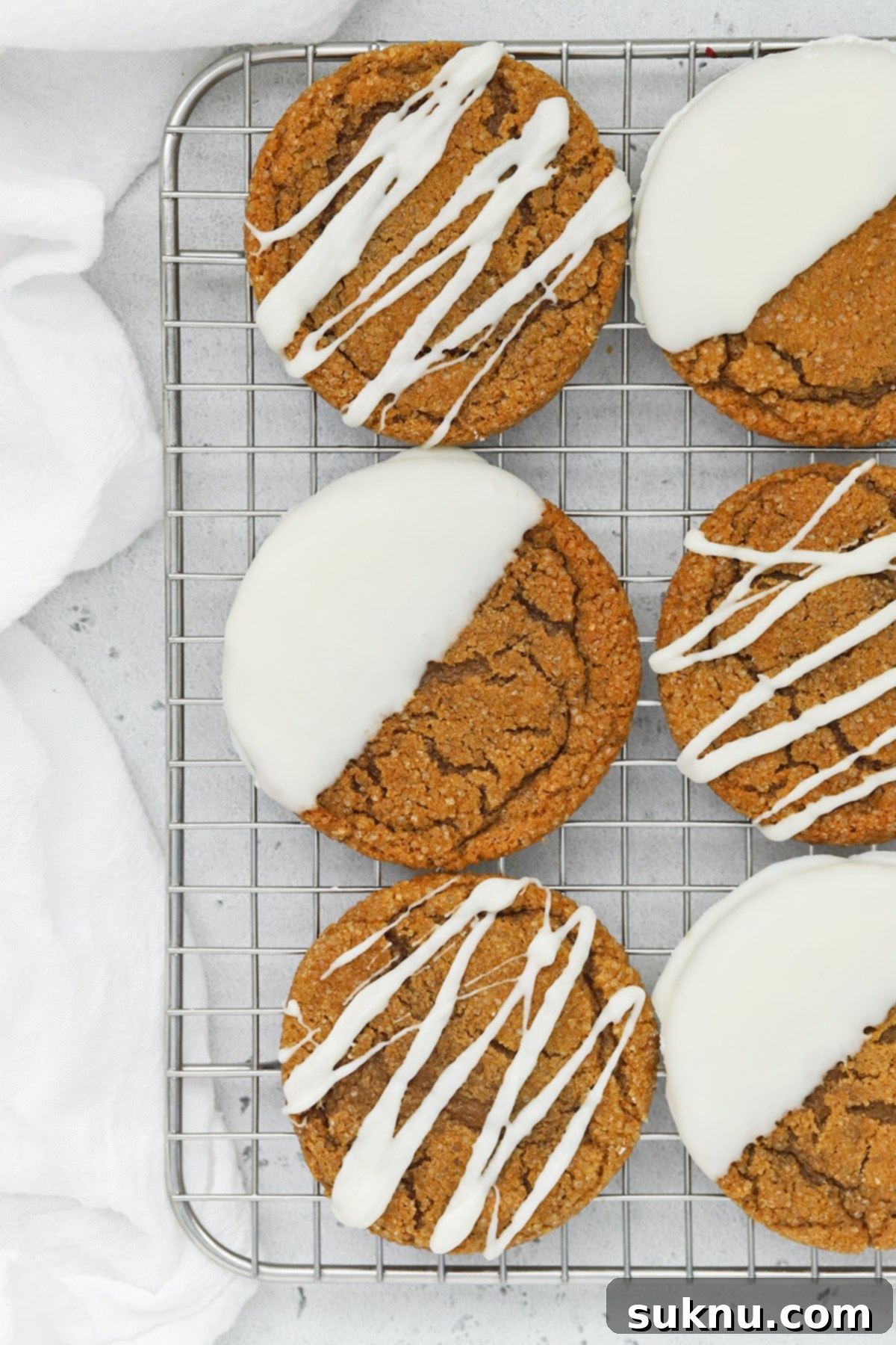 Overhead view of soft, chewy gluten-free ginger cookies drizzled and dipped in white chocolate
