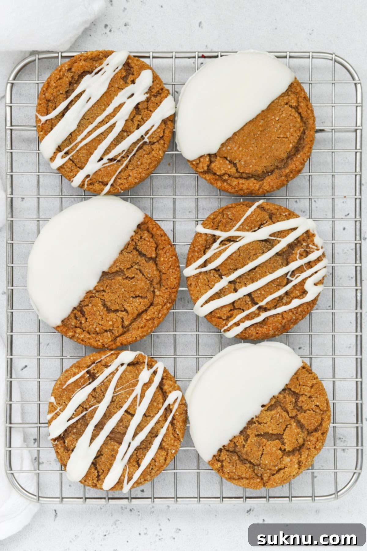 Overhead view of soft, chewy gluten-free ginger cookies drizzled and dipped in white chocolate