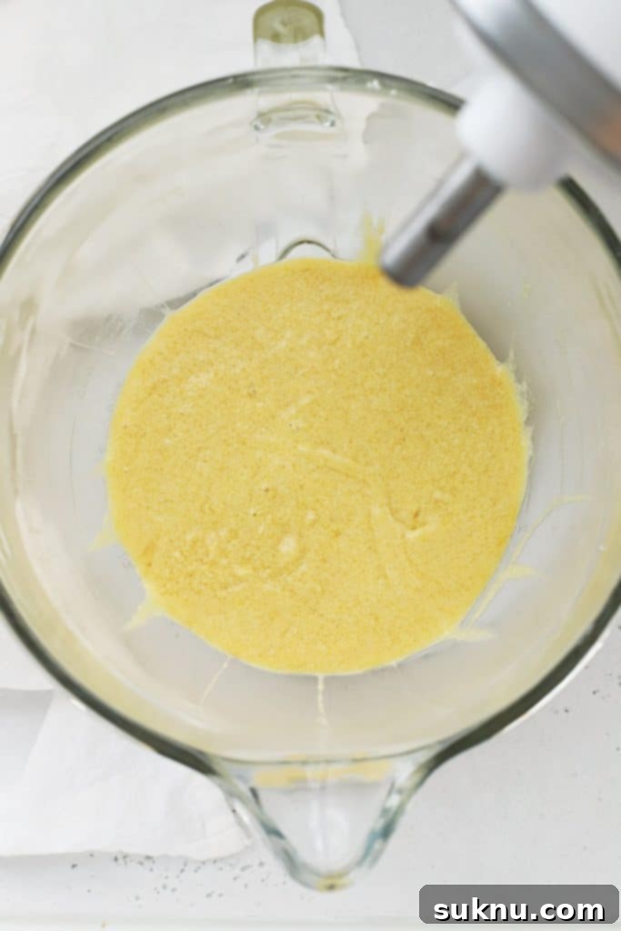 Creamed butter and sugar for peppermint crinkle cookies, a light and fluffy mixture in a mixing bowl.