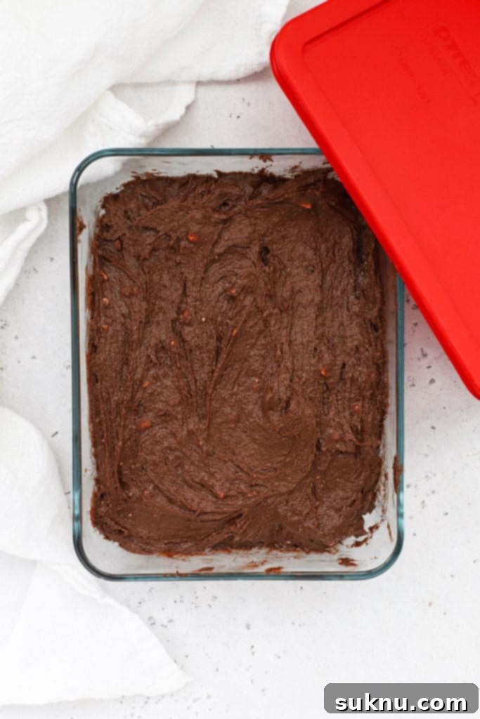 Chilled dough for gluten-free peppermint chocolate crinkle cookies, firm and ready for rolling.