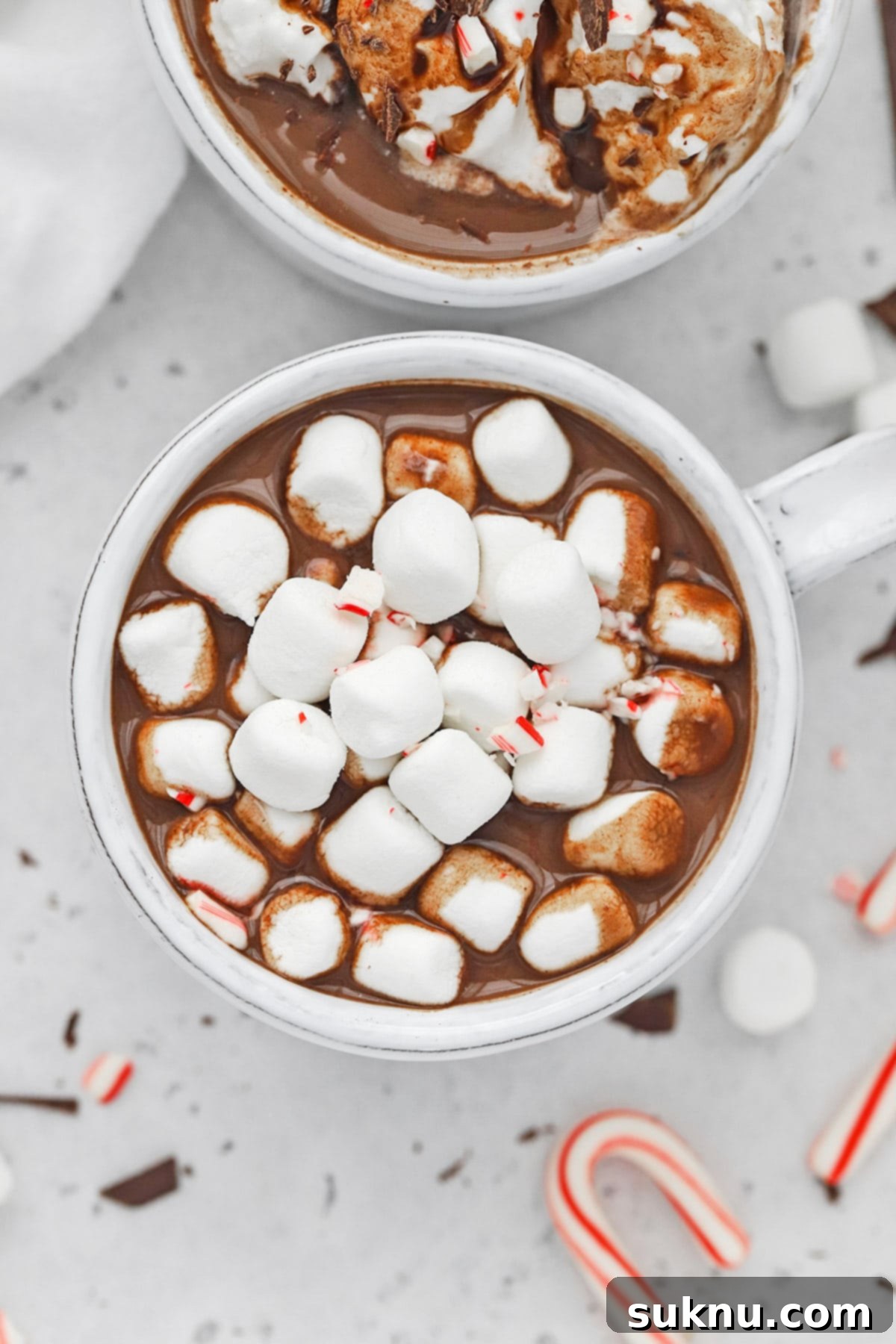 Peppermint Dream Vegan Cocoa 2 Overhead view of a steaming mug of rich vegan peppermint hot chocolate, beautifully topped with fluffy marshmallows.