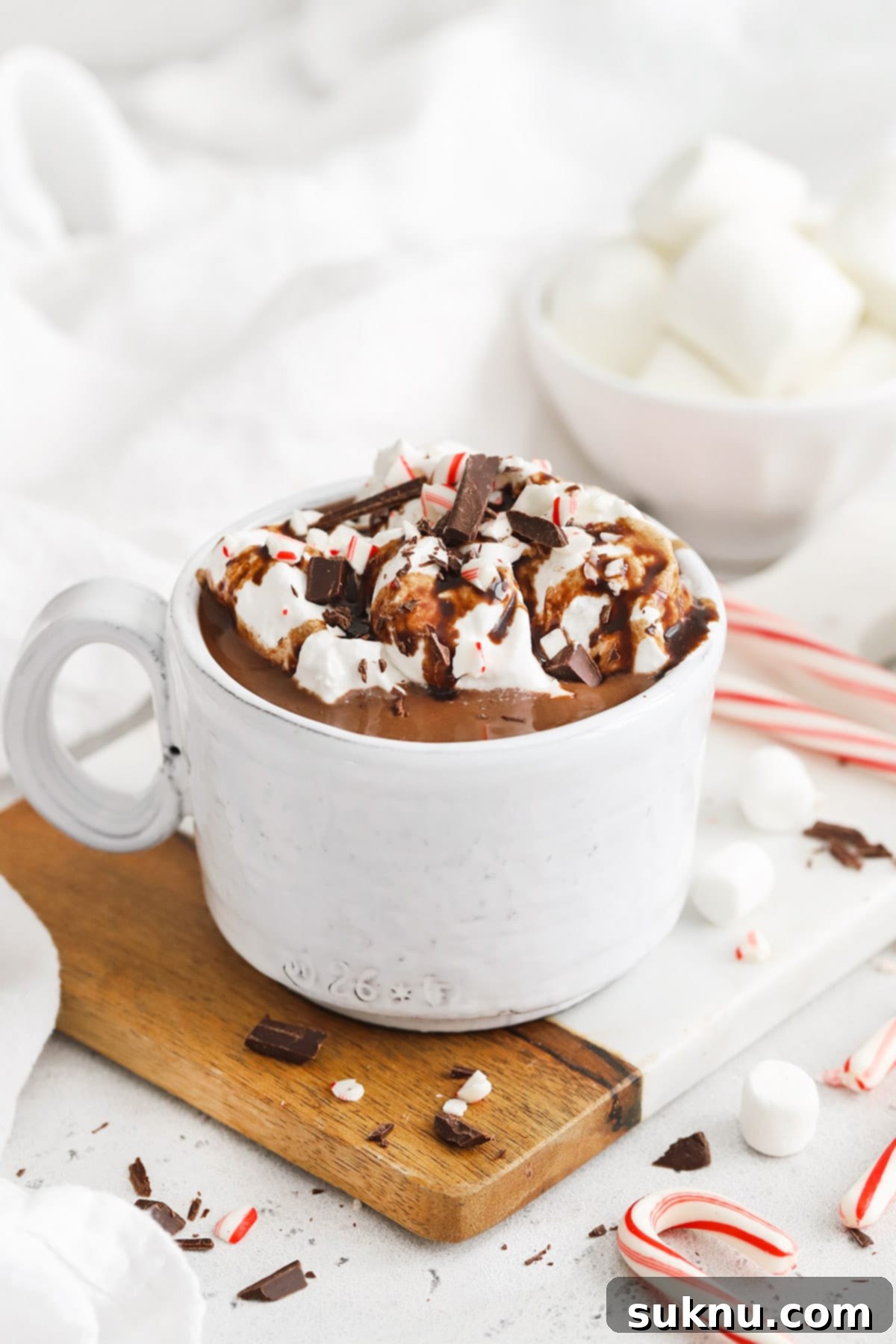 Peppermint Dream Vegan Cocoa 12 Front view of a cozy cup of steaming vegan peppermint hot chocolate, topped with a luscious layer of whipped cream, from Sweets & Thank You.