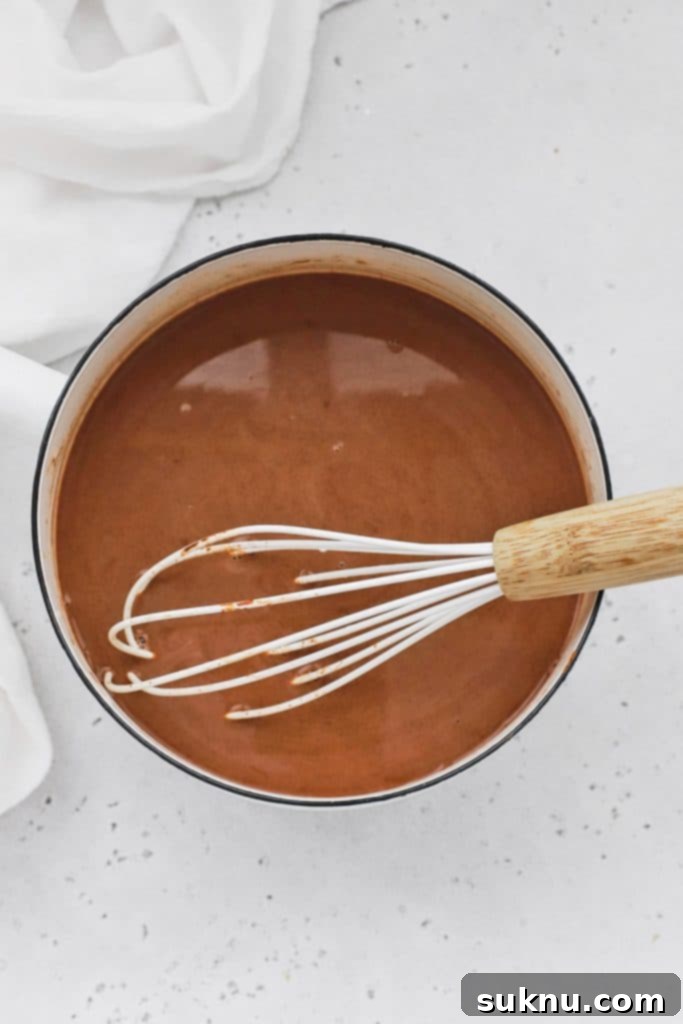 Peppermint Dream Vegan Cocoa 6 A simmering pot of freshly made vegan peppermint hot chocolate, creating a warm and inviting steam in the kitchen.