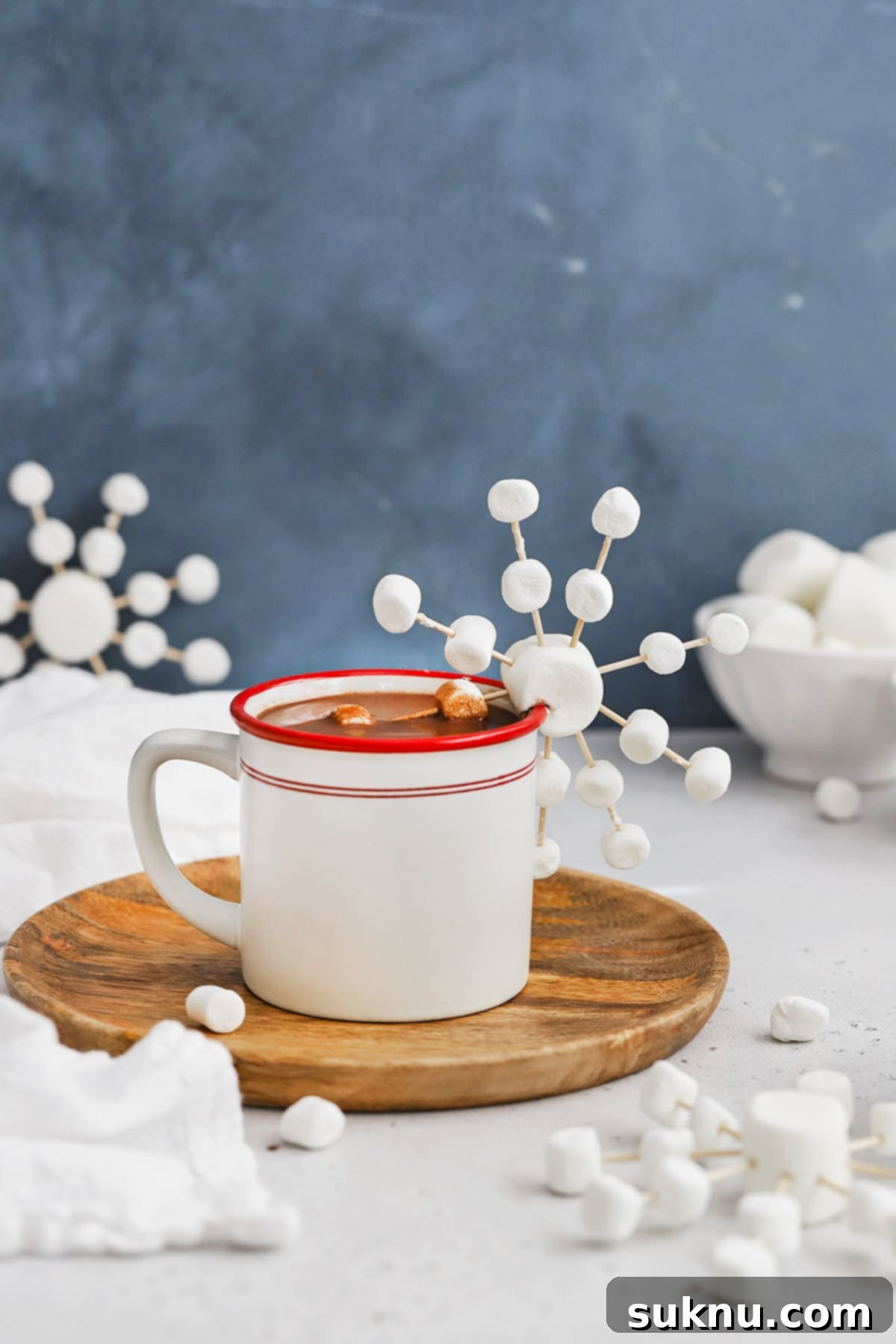 Marshmallow Snowflake Magic 2 Front view of marshmallow snowflakes made out of marshmallows and toothpicks on a mug of peppermint hot chocolate. A perfect winter activity and hot cocoa topping.