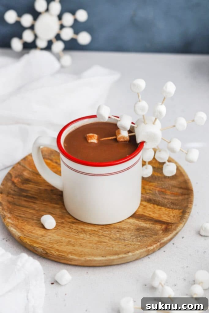 Marshmallow Snowflake Magic 14 Front view of a beautiful marshmallow snowflake resting on a mug of peppermint hot chocolate, creating a delightful winter scene.