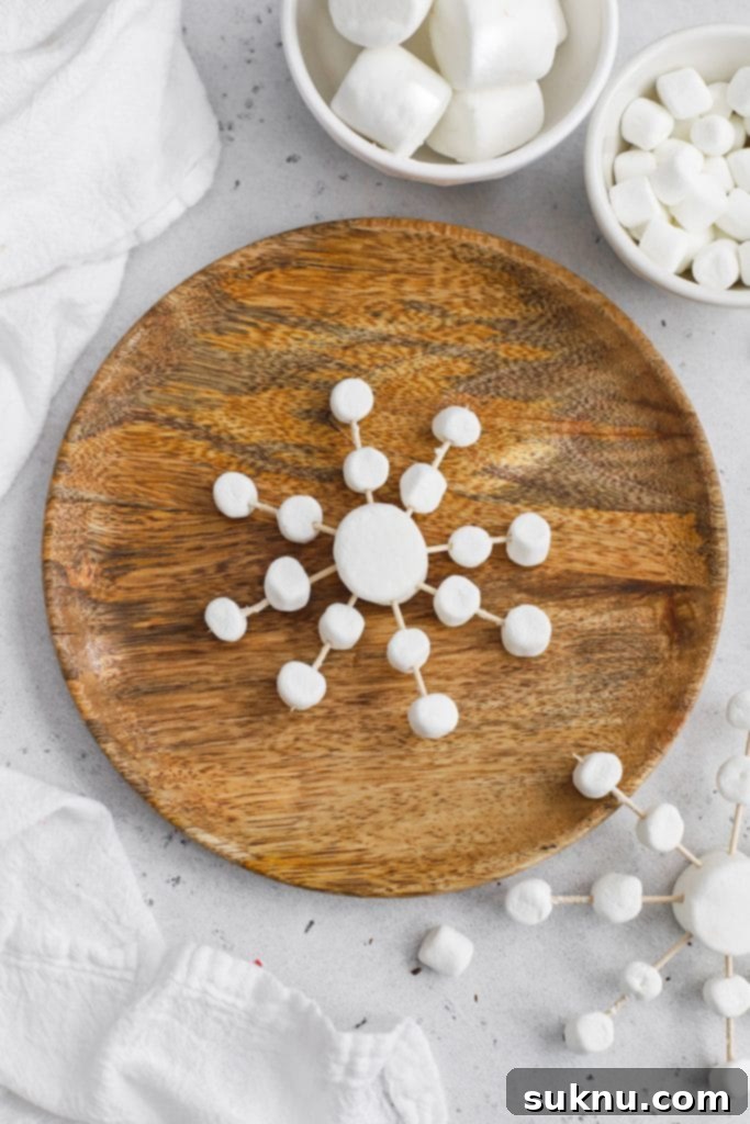 Marshmallow Snowflake Magic 4 Close-up overhead view of marshmallow snowflakes, showcasing the delicate design created with mini marshmallows.