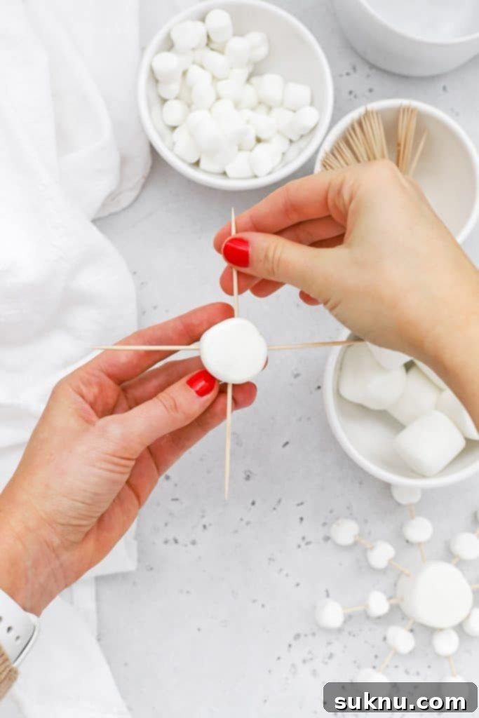 Marshmallow Snowflake Magic 6 Next step in making marshmallow snowflakes, showing multiple toothpicks forming the star shape.