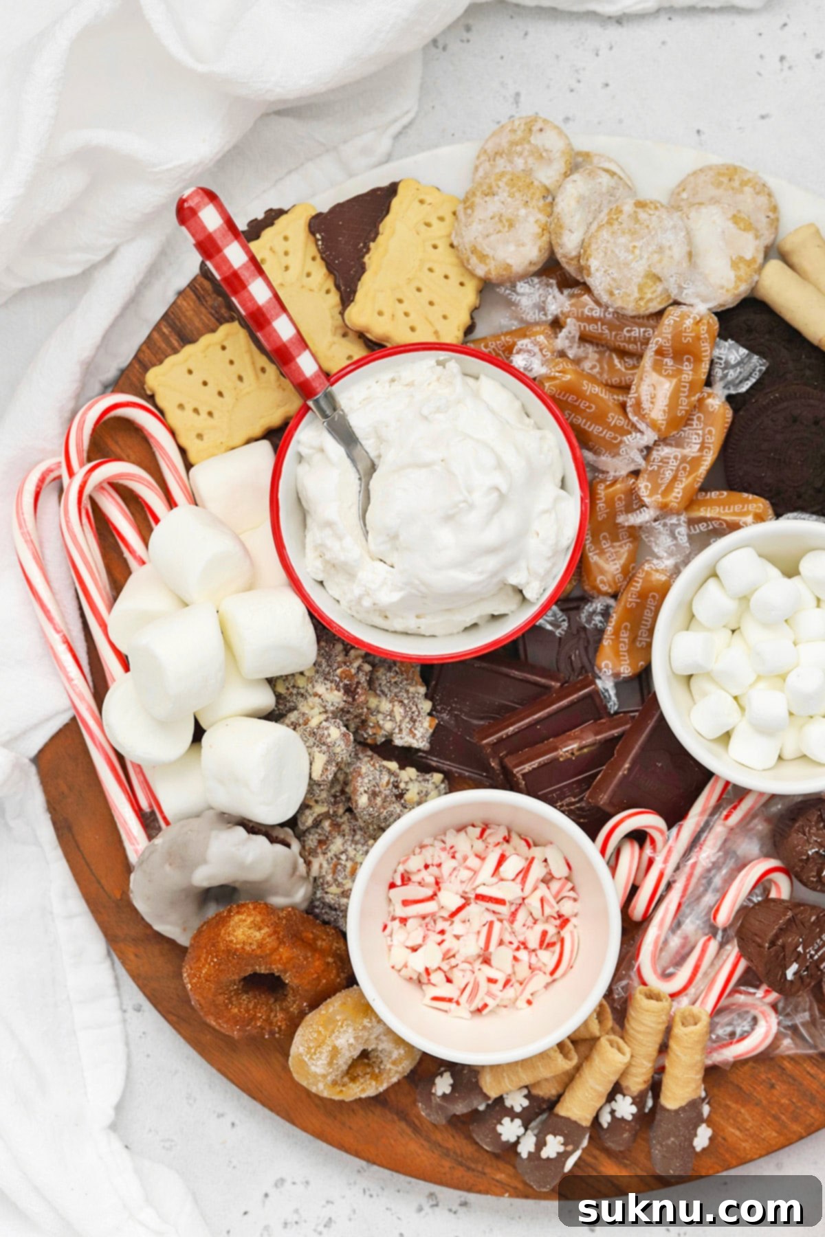 An overhead view of a beautifully composed gluten-free hot chocolate charcuterie board, highlighting the strategic placement of various toppings and mix-ins.