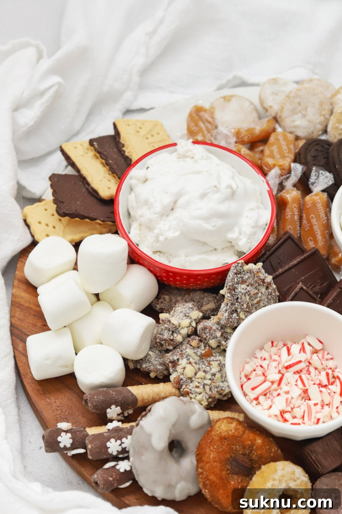A beautiful front perspective of a gluten-free hot chocolate charcuterie board, loaded with an array of mix-ins and toppings, creating an inviting spread for a winter celebration.