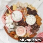 Overhead view of a gluten-free hot chocolate charcuterie board with toppings and mix-ins