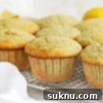 Front view of gluten-free lemon poppy seed muffins cooling on a cooling rack