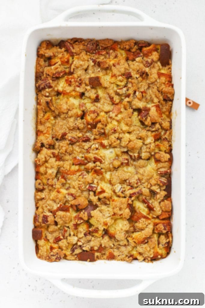 Holiday Gluten Free Eggnog French Toast Bake 12 Overhead view of a freshly baked gluten-free eggnog french toast casserole with a golden brown streusel topping, hot out of the oven