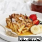 Holiday Gluten Free Eggnog French Toast Bake 16 Front view of gluten-free eggnog french toast casserole topped with powdered sugar and maple syrup