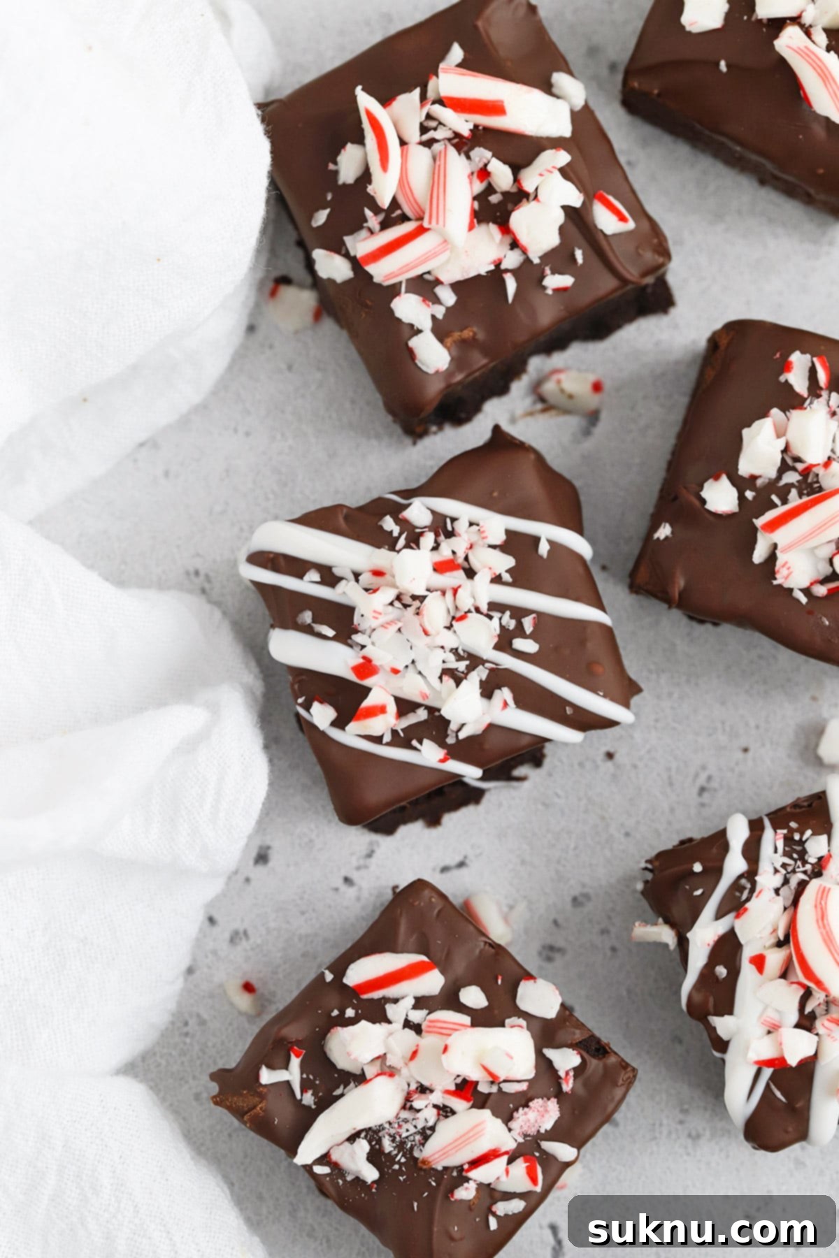 Overhead view of gluten-free peppermint brownie bites topped with crushed candy canes, ready for holiday festivities and perfect for gluten-free diets.