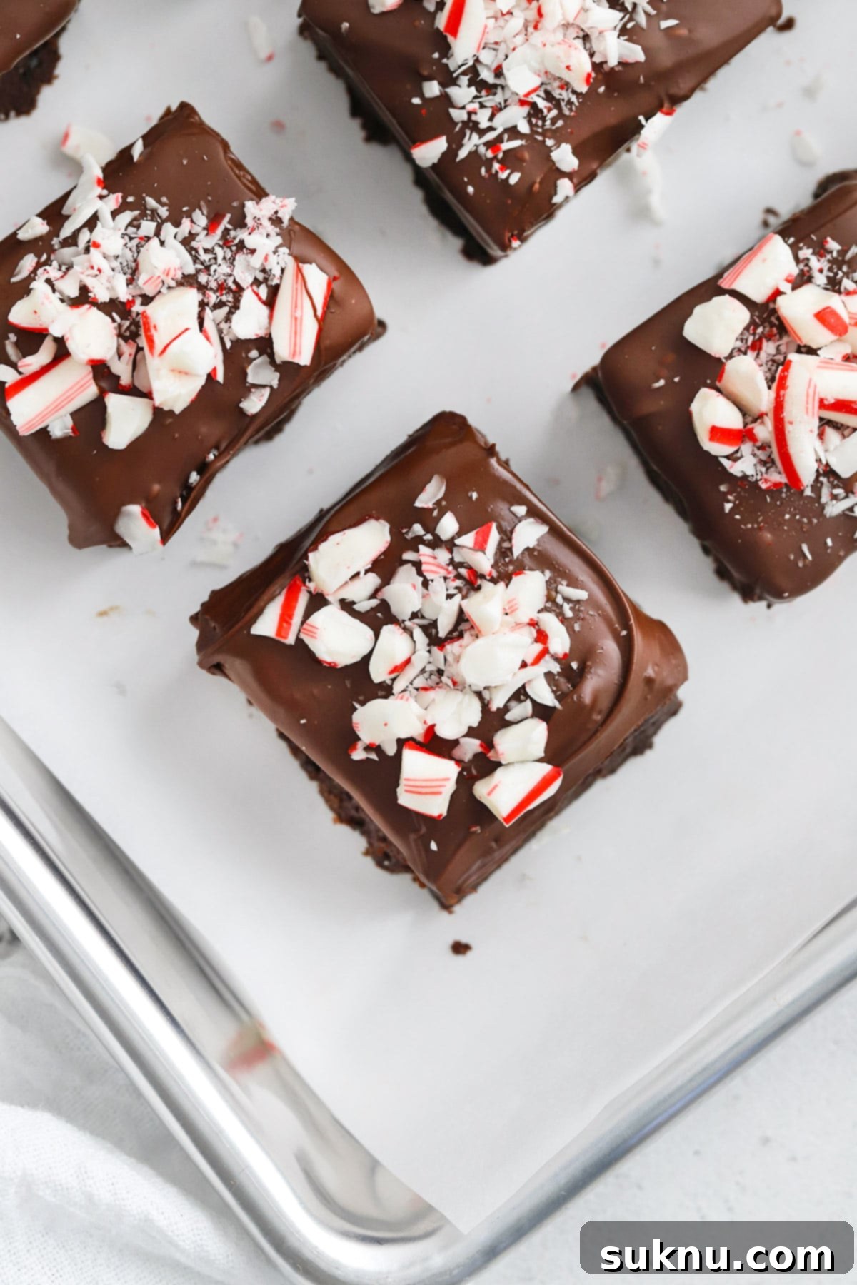 Overhead view of a tray of freshly made gluten-free peppermint brownie bites, perfectly coated and sprinkled, ready to be served for the holidays.