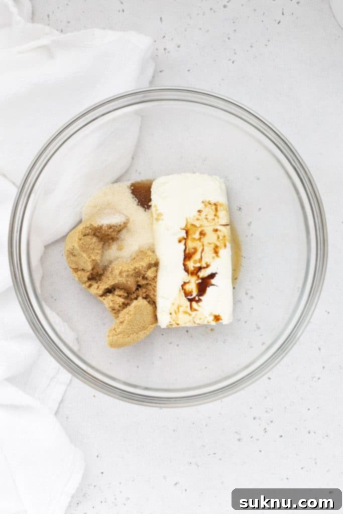 Brown Sugar Cream Cheese Fruit Dream 4 Ingredients for Brown Sugar Cream Cheese Fruit Dip in a glass mixing bowl, ready to be blended