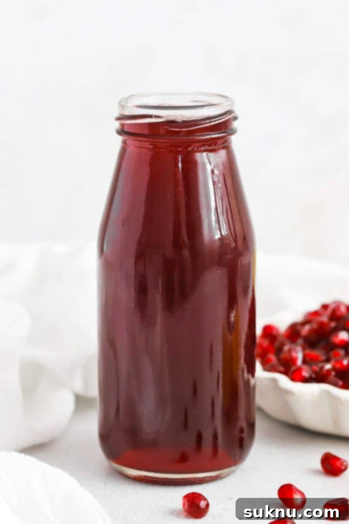Easy Homemade Grenadine Three Ingredients 3 Front view of homemade grenadine syrup in a jar.