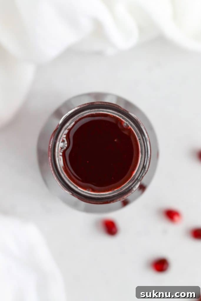 Easy Homemade Grenadine Three Ingredients 4 Overhead view of a jar of homemade grenadine syrup for mocktails