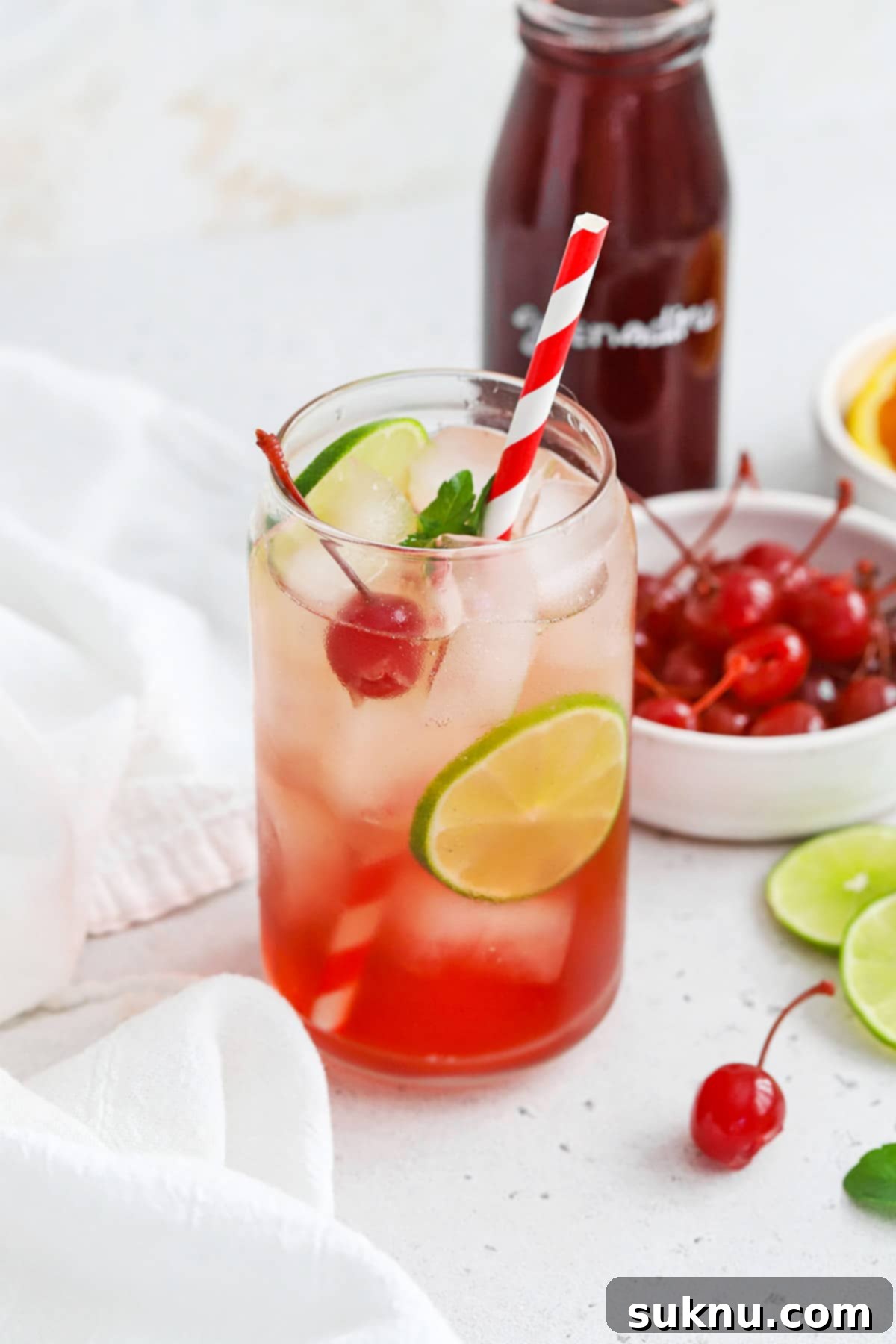 Classic Shirley Temple 2 Front view of a classic shirley temple drink garnished with lime, cherry, and fresh mint