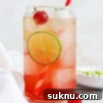 Classic Shirley Temple 13 Front view of a classic shirley temple drink garnished with lime, cherry, and fresh mint