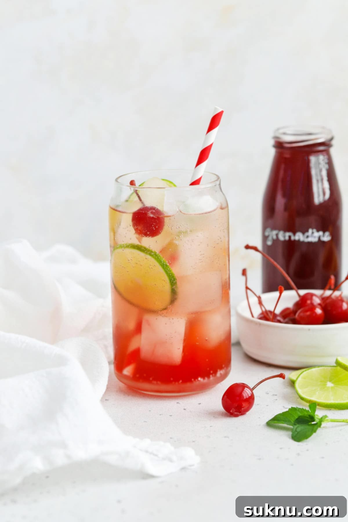 Classic Shirley Temple 4 Front view of a classic shirley temple drink garnished with lime, cherry, and fresh mint