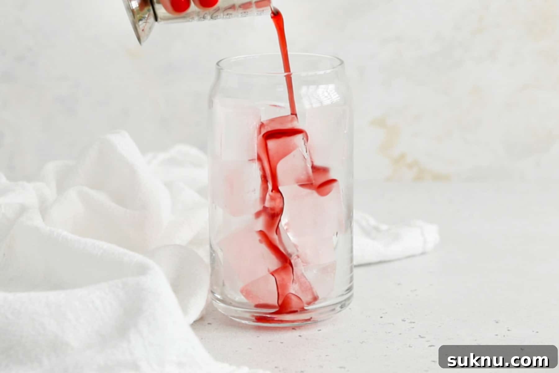 Classic Shirley Temple 6 Pouring grenadine into a glass to make a classic shirley temple drink