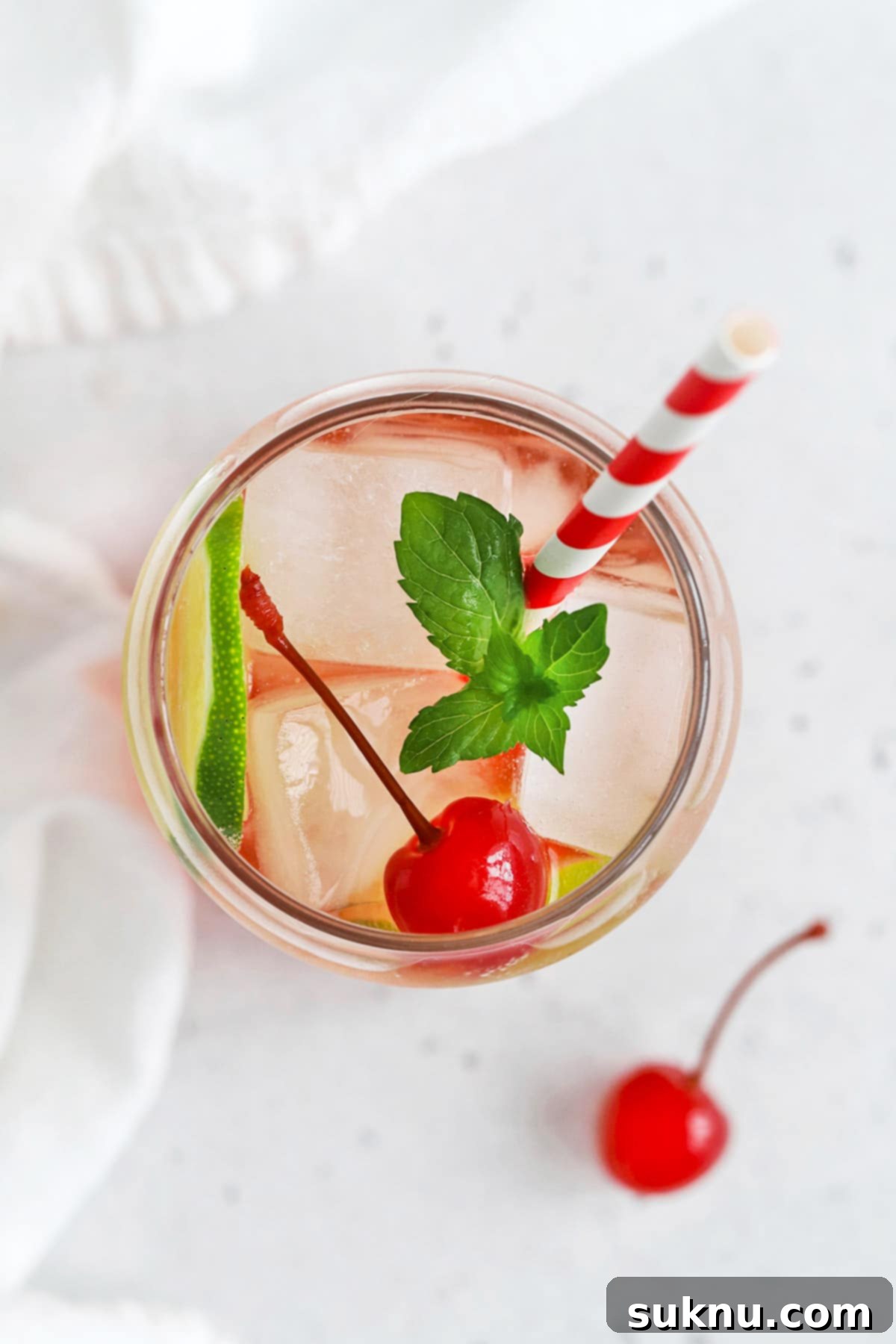 Classic Shirley Temple 8 Overhead view of a classic shirley temple drink garnished with lime, cherry, and fresh mint