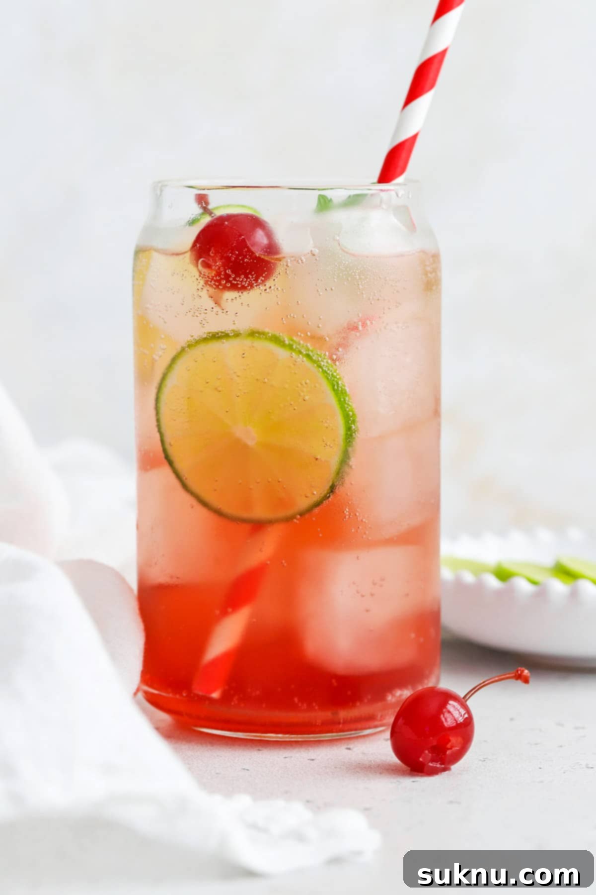 Classic Shirley Temple 9 Front view of a classic shirley temple drink garnished with lime, cherry, and fresh mint