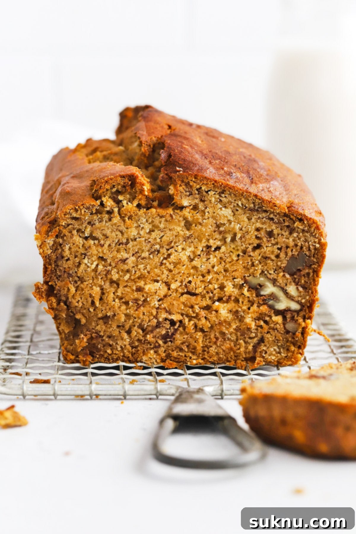 Perfectly baked banana bread loaf on a cooling rack