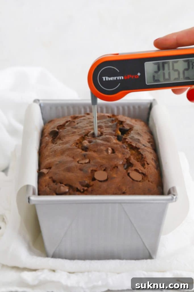 Digital display of an instant read thermometer showing the internal temperature of banana bread.