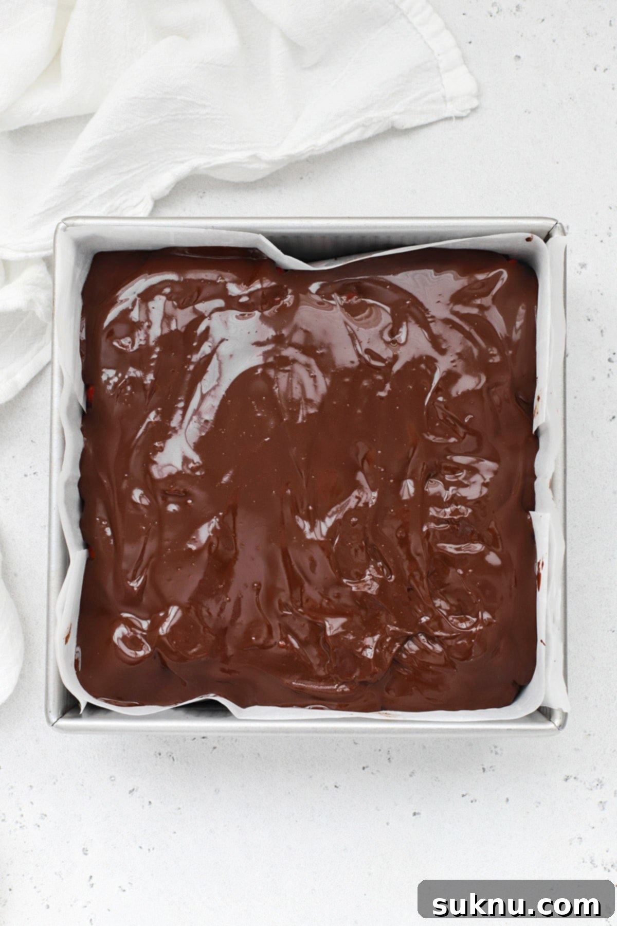 Overhead view of gluten-free chocolate covered strawberry brownies, perfectly set with glossy ganache, showcasing the fresh strawberries beneath.