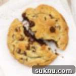 Decadent Gluten Free Levain Chocolate Chip Cookies 9 gluten free levain chocolate chip cookie being pulled apart to reveal a gooey center