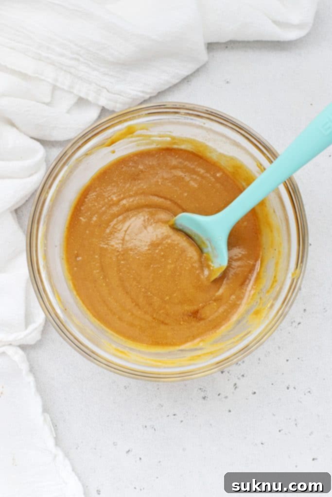 Stirring the ingredients for gluten-free peanut butter granola bars