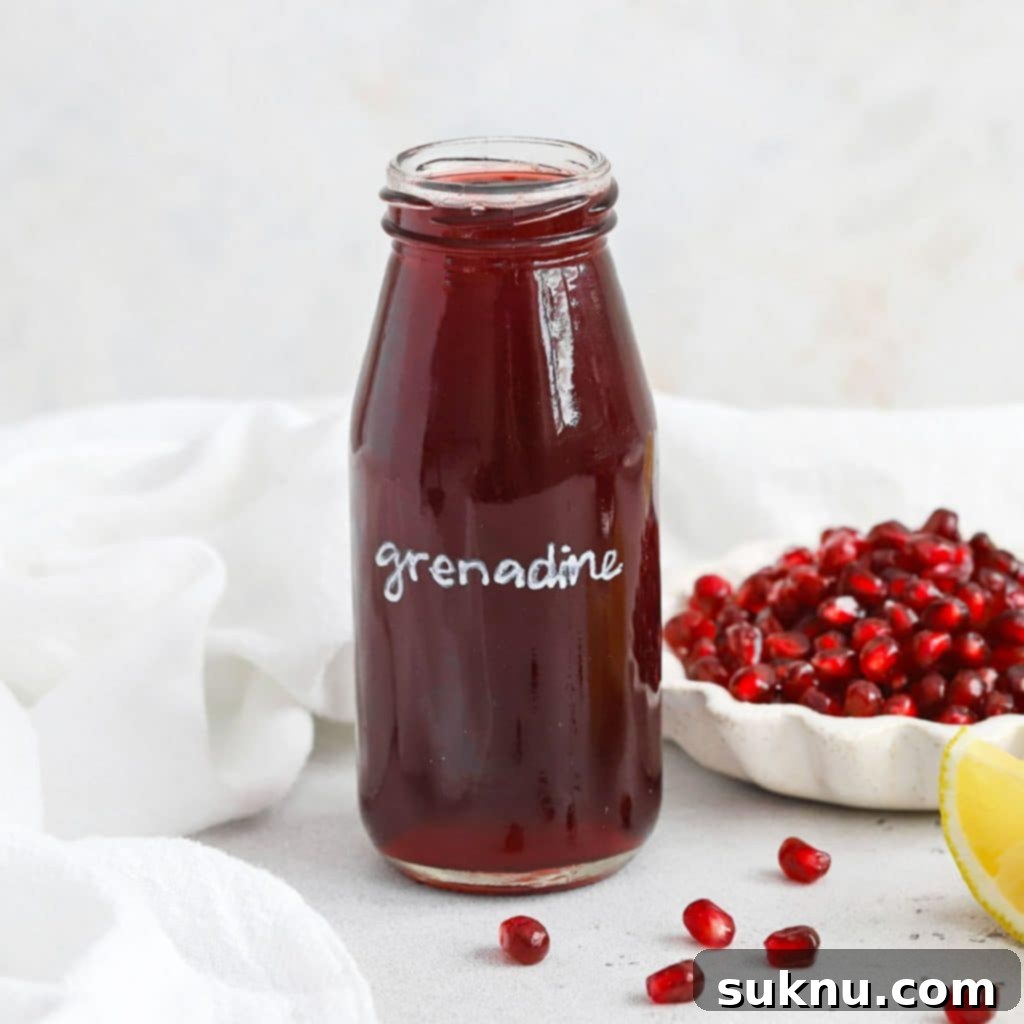 Close-up of a bottle of vibrant red grenadine cocktail syrup