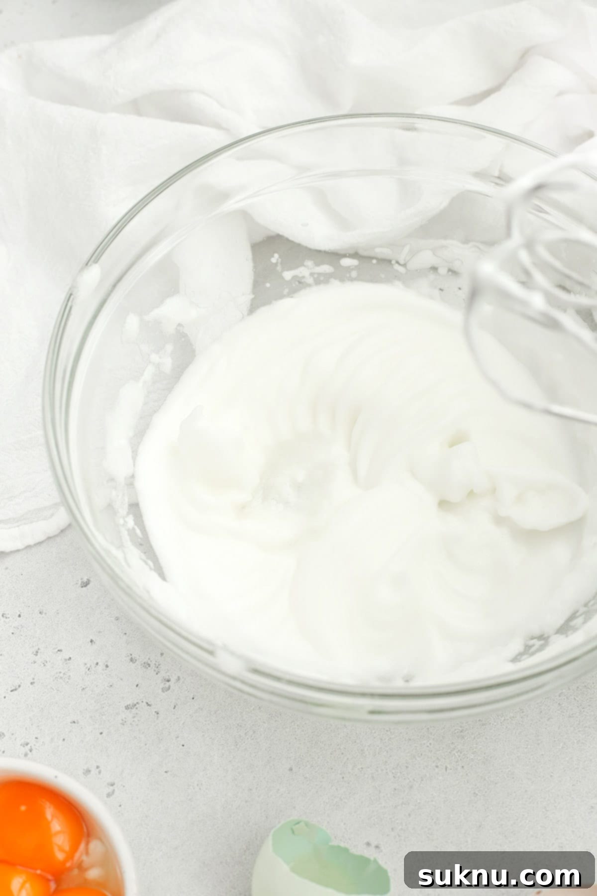Mastering Whipped Egg Whites: Stiff and Soft Peak Techniques 9 Egg whites whipped to soft peaks in a bowl, ready for use