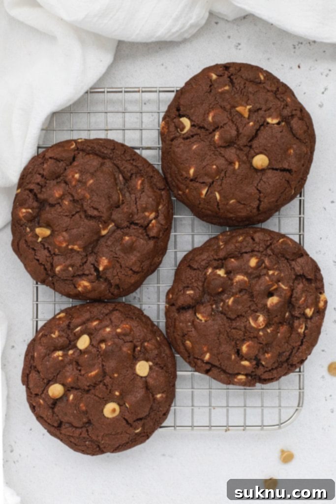 Overhead view of thick gluten-free chocolate peanut butter chip cookies cooling on a wire rack