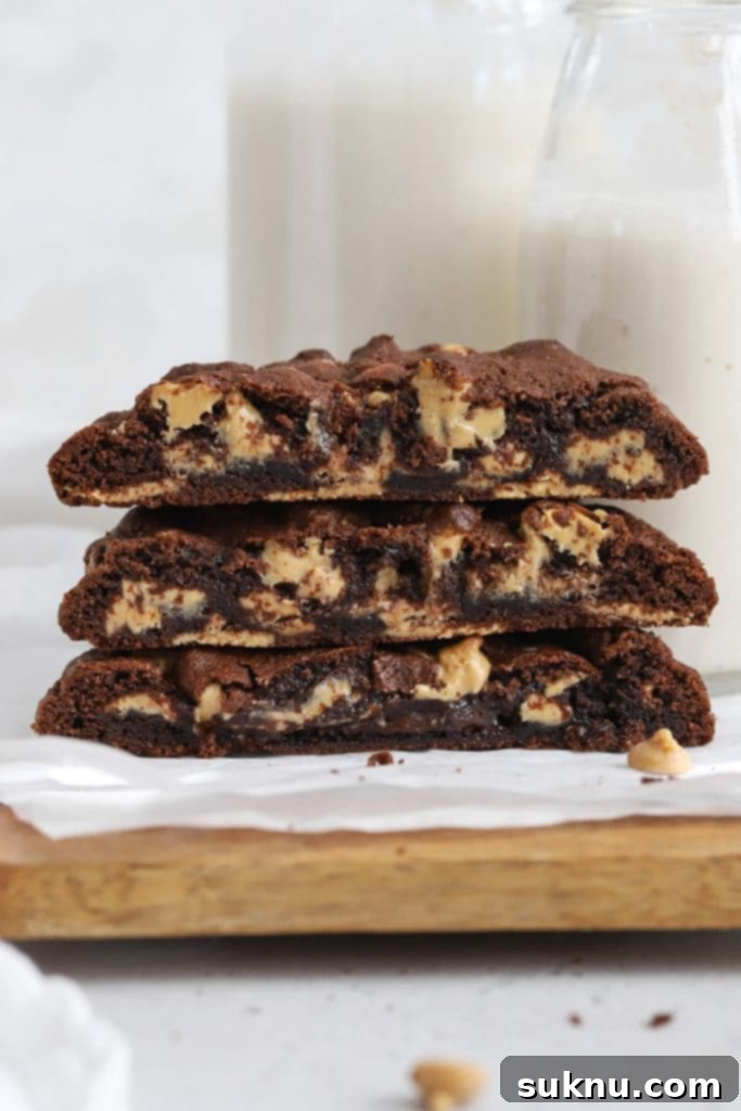 Front view of gluten-free Levain-style dark chocolate peanut butter chip cookies, revealing their gooey center